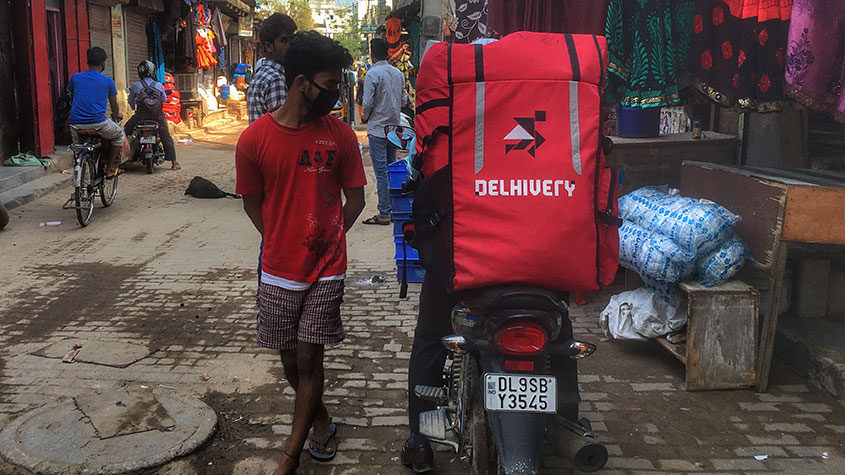 Delhivery rider on a scooter