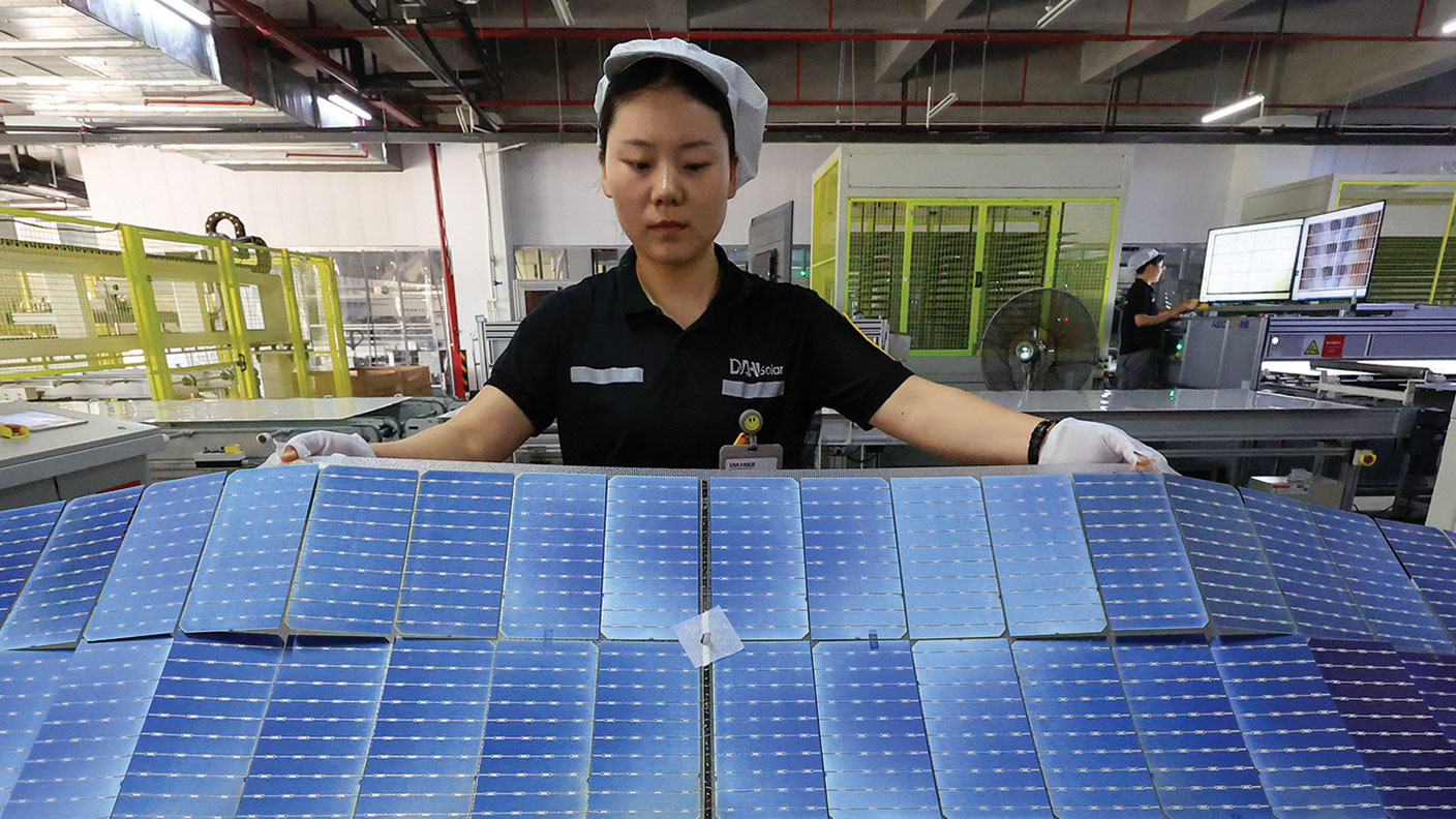 Employee checking solar panels