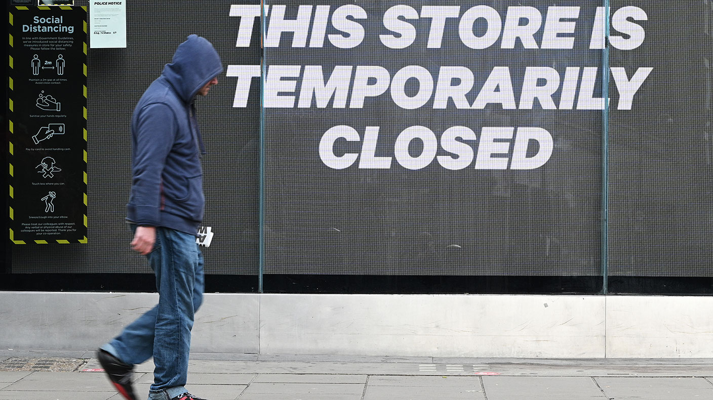 A man walks past a closed shop