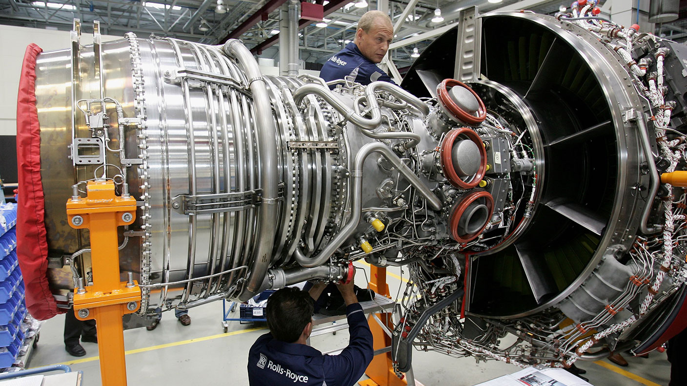 Rolls-Royce workers with an aircraft jet engine