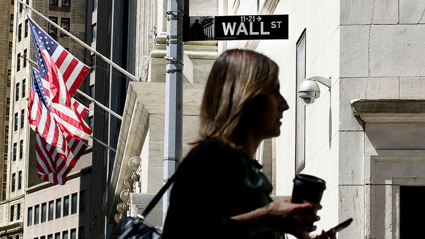 Woman walking on Wall Street
