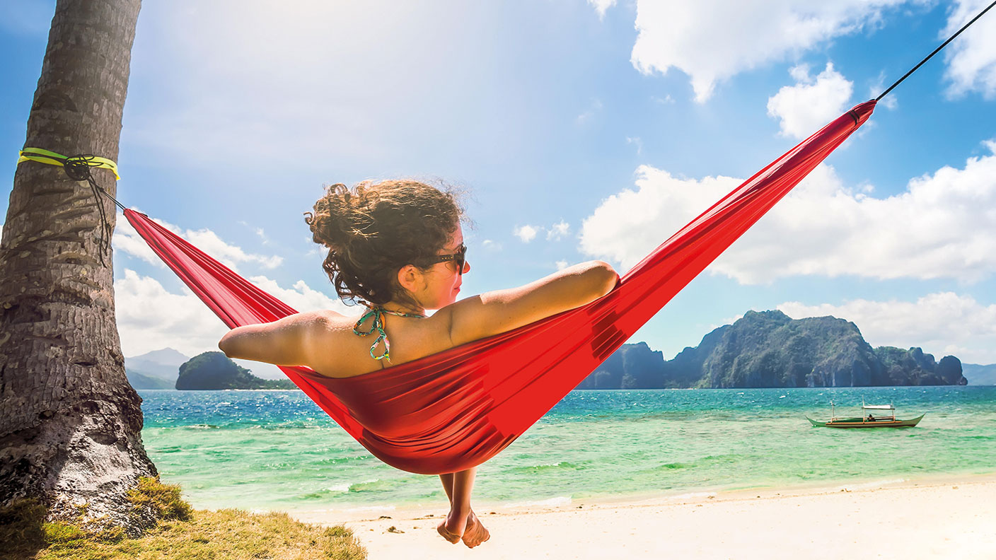 Woman in a hammock on a tropical beach