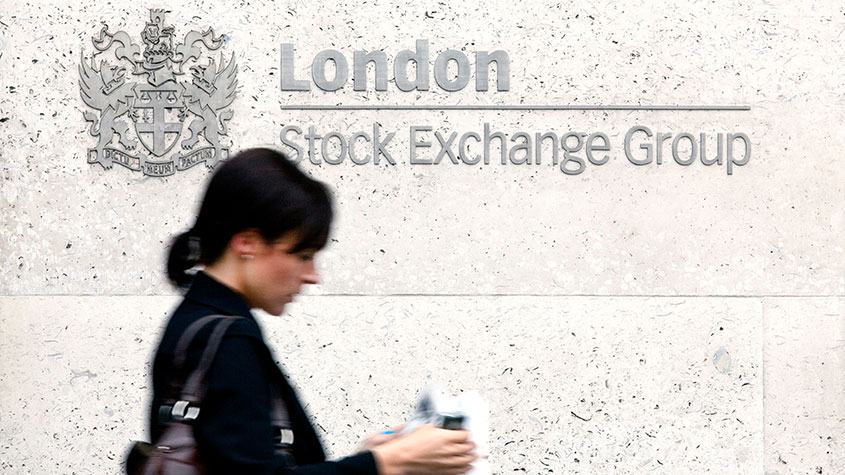 Woman walking by the London Stock Exchange