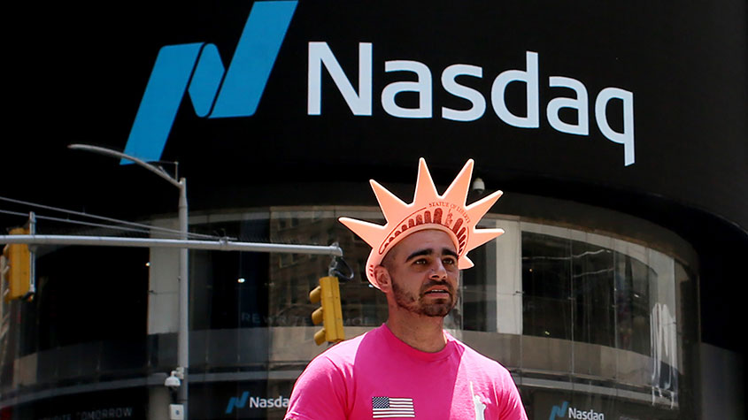 Man in a statue of liberty hat by the Nasdaq stock exchange