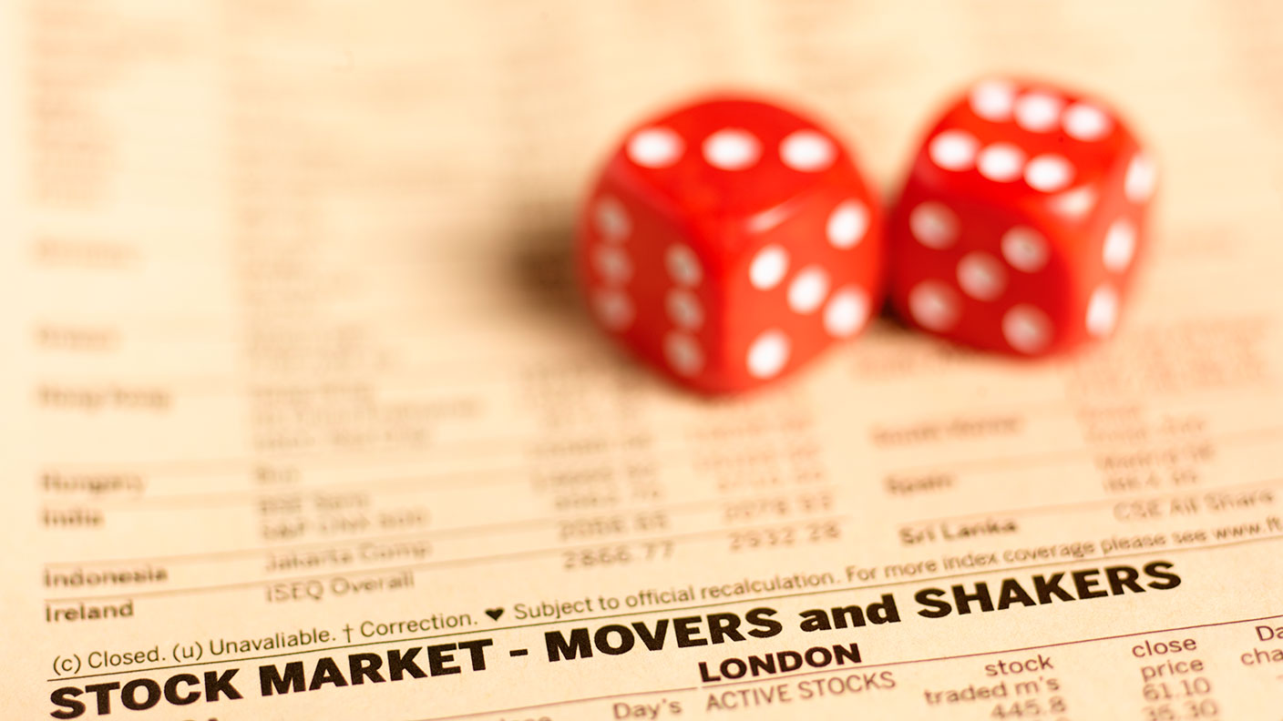 Pair of dice on financial pages © Getty Images