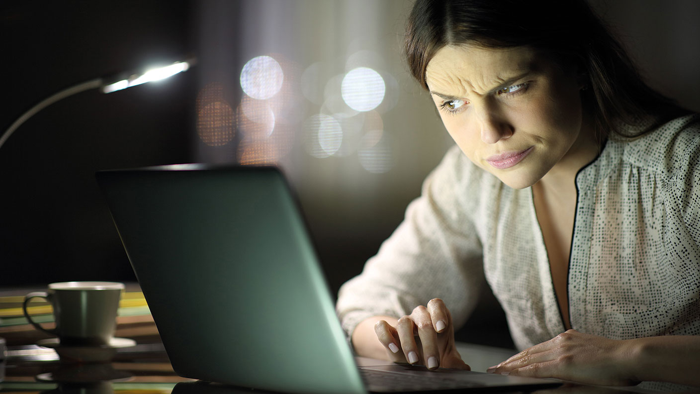 Woman frowning at a laptop 