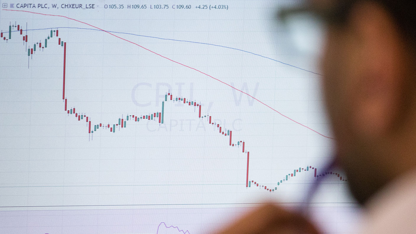 Trader looking at a financial chart © Chris Ratcliffe/Bloomberg via Getty Images
