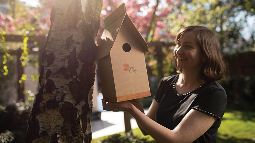 Woman with a cardboard bird box