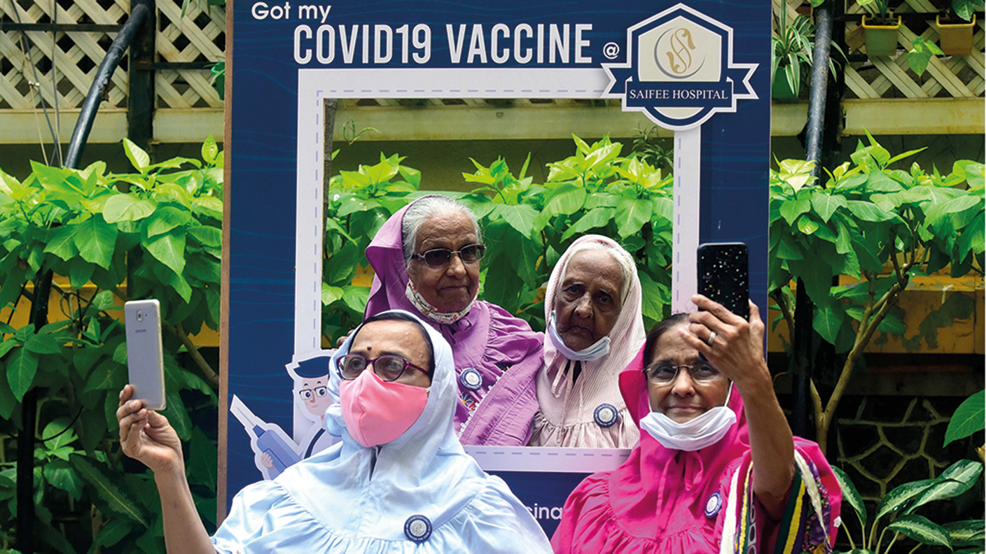Indian women taking selfies after having the Covid vaccine