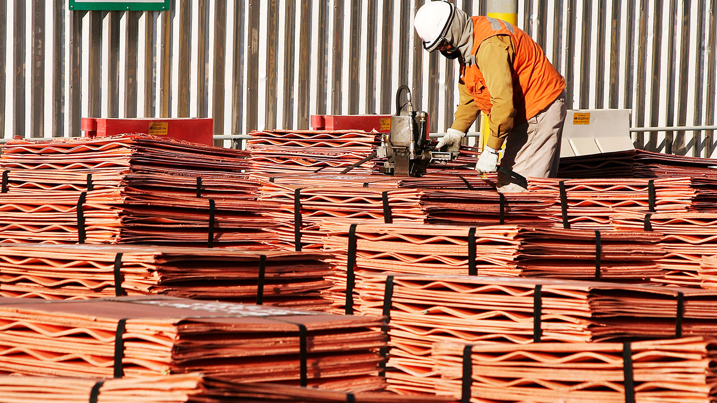 Worker with piles of copper