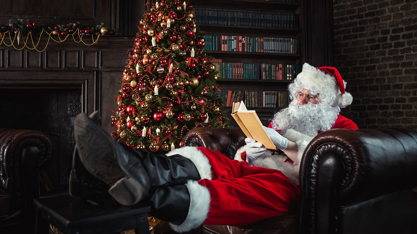 Father Christmas reading a book