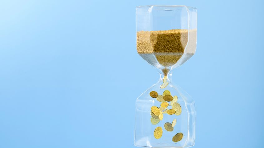 hourglass with golden sand flowing down become gold coins