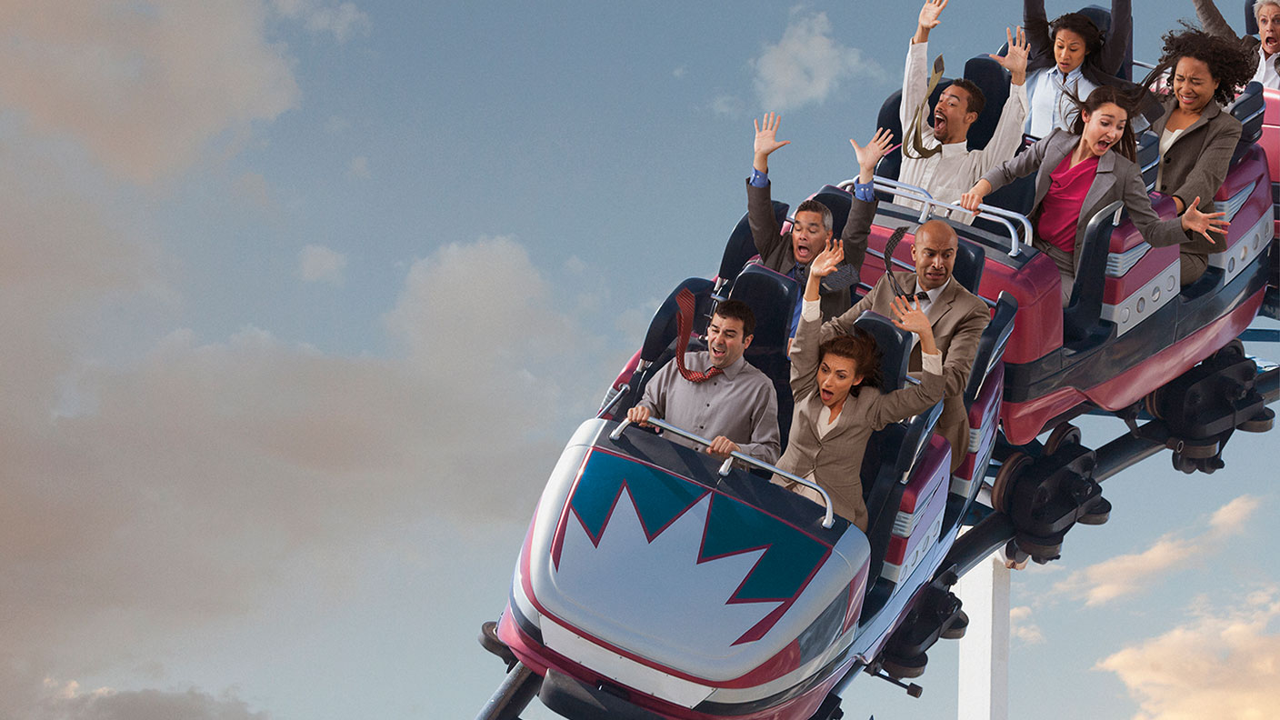 People in suits pretending to ride a rollercoaster