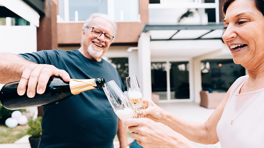 Premium bond winners celebrating with champagne