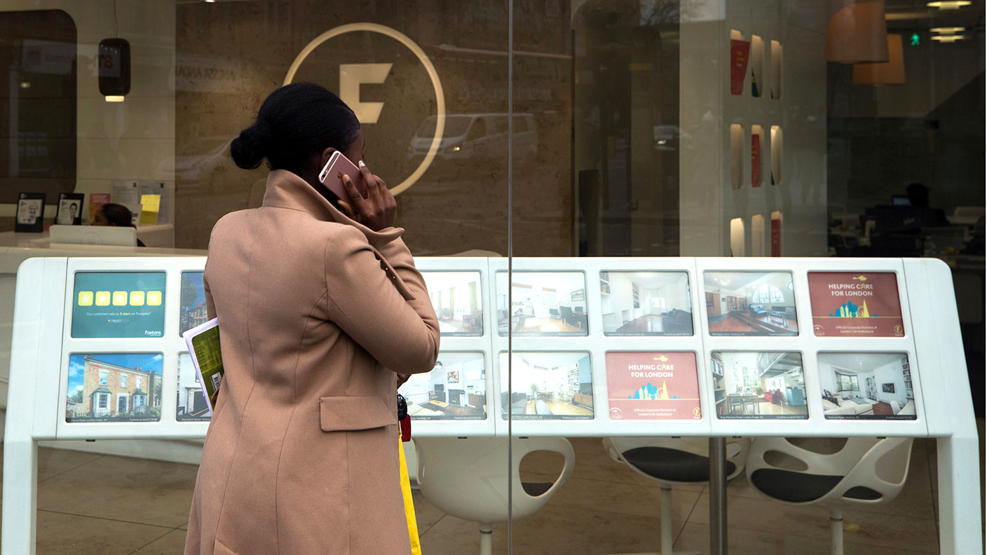 Woman looking in an estate agent&#039;s window