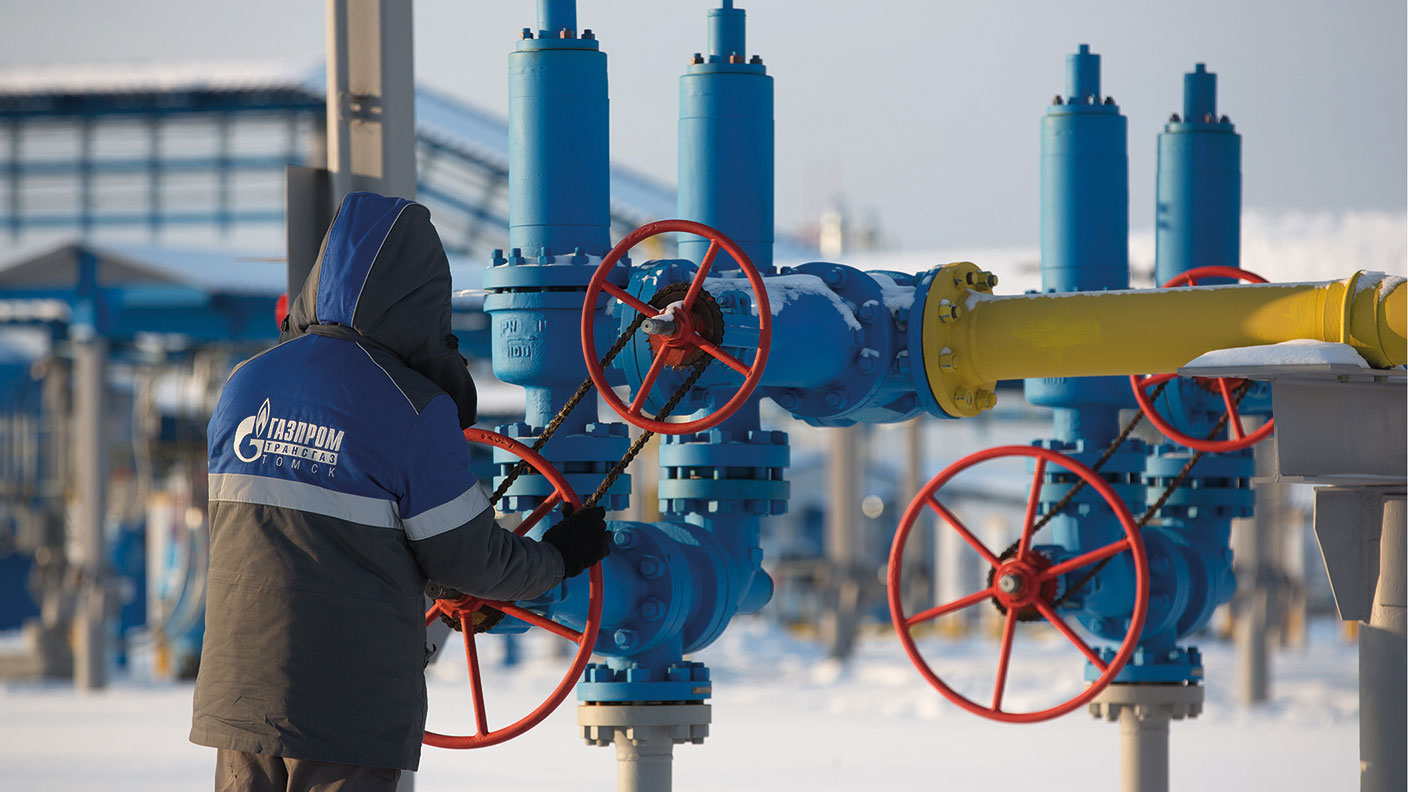 Gazprom worker turning a gas valve wheel