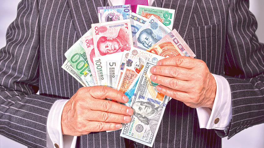 Man in a pinstripe suit holding various banknotes